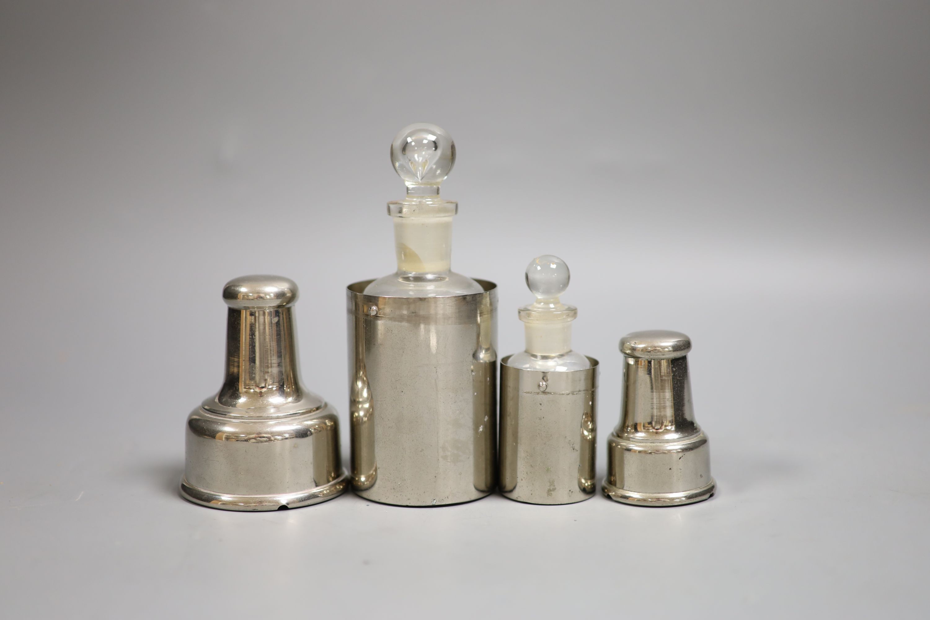 Two chrome plated cased glass medicine bottles, tallest 15cm